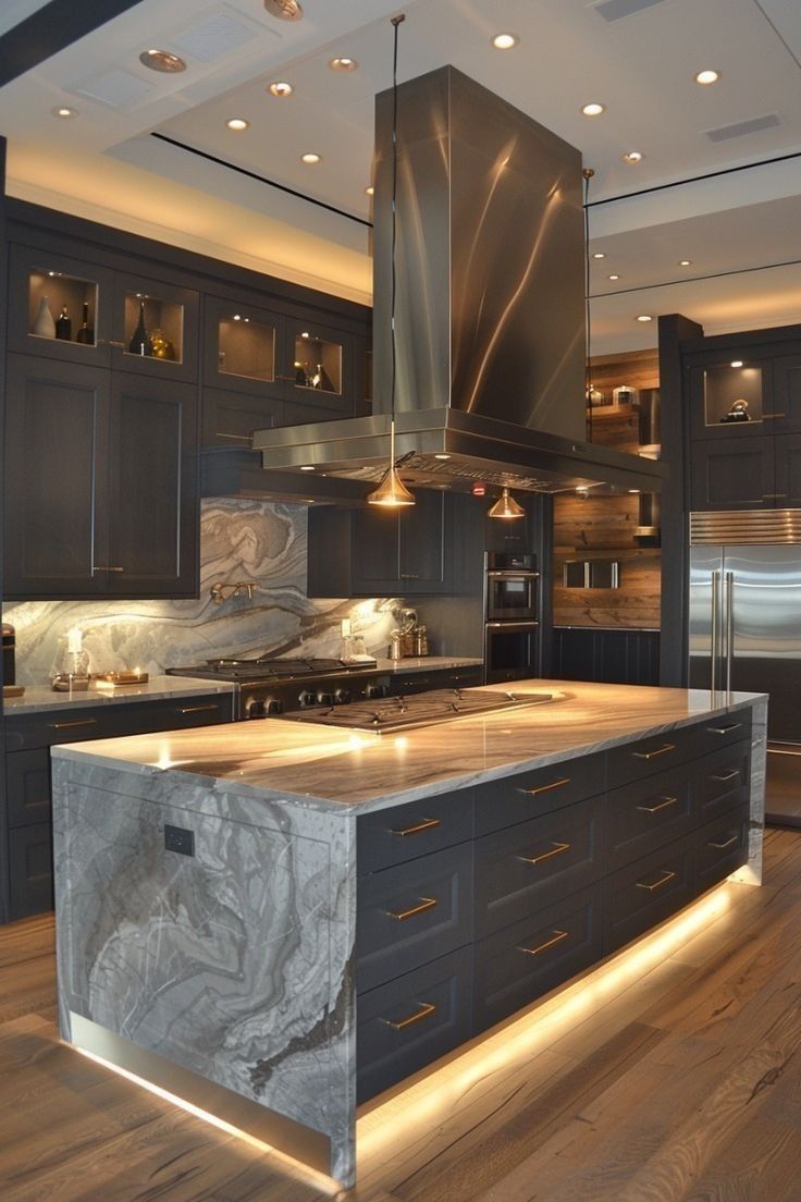 Grey kitchen with veined stone island and warm under-cabinet light